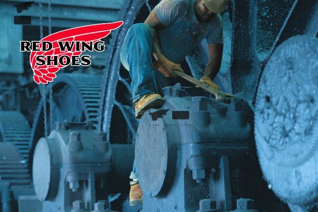 Red Wing man working on large machinery
