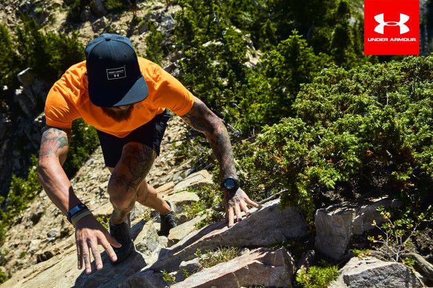 UA down shot of man climbing rocks